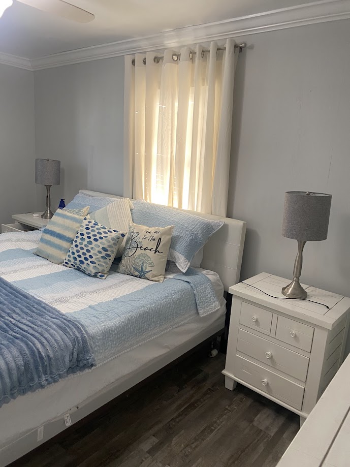 A cozy bedroom with a light blue and white color scheme
